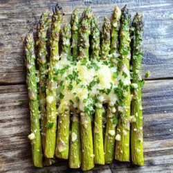To make lemon garlic roasted asparagus, start with fresh asparagus. Choose a pound of bright green, firm stalks. Look for tips that are tightly closed and vibrant. This ensures you get the best flavor and crispness. Trim the tough ends of the asparagus before cooking. This step is key for a tender bite. The magic of this dish lies in its simple seasonings. Here’s what you need: - 3 tablespoons olive oil - 4 cloves garlic, minced - Zest of 1 lemon - 2 tablespoons fresh lemon juice - 1 teaspoon sea salt - 1/2 teaspoon black pepper - 1/4 teaspoon red pepper flakes (optional) - 2 tablespoons grated Parmesan cheese (or a vegan alternative) - Fresh parsley, chopped (for garnish) These ingredients create a burst of flavor. The lemon adds brightness, while garlic brings depth. The olive oil helps everything roast beautifully. You can customize this recipe by adding a few optional ingredients. If you like a little heat, use red pepper flakes. For a cheesy touch, sprinkle more Parmesan before serving. You can also swap in nutritional yeast for a vegan option. Each change adds a unique flair to the dish. First, set your oven to 400°F (200°C). This heat helps the asparagus roast well. Next, take 1 pound of fresh asparagus. Trim the ends to remove any tough parts. You want only the tender stalks. Rinse the asparagus under cold water to clean it. Pat it dry with a towel. This step helps the marinade stick better. In a large mixing bowl, add 3 tablespoons of olive oil. Then, add 4 cloves of minced garlic. The garlic gives a strong flavor that pairs well with the asparagus. Next, add the zest of 1 lemon and 2 tablespoons of fresh lemon juice. These ingredients brighten up the dish. Now, sprinkle in 1 teaspoon of sea salt, 1/2 teaspoon of black pepper, and 1/4 teaspoon of red pepper flakes if you like a bit of heat. Mix everything well until combined. Now, add the trimmed asparagus to the bowl. Toss it gently to coat each piece with the lemon garlic mixture. Spread the asparagus onto a baking sheet lined with parchment paper. Make sure the stalks are in a single layer. This helps them roast evenly. Place the sheet in the preheated oven. Roast for 12-15 minutes, or until the asparagus is tender and slightly crispy. In the last 2 minutes, sprinkle 2 tablespoons of grated Parmesan cheese on top. This adds a creamy touch. Once done, take it out and let it cool for a minute. Finish by garnishing with fresh parsley. Enjoy this dish straight away! For the full recipe, check the details above. When choosing asparagus, look for firm, bright green stalks. The tips should be tightly closed and fresh. Avoid any that feel soft or limp. Thicker stalks provide a meatier bite, while thinner ones cook faster. I prefer medium-sized asparagus for balance in texture and flavor. To get the best results, start with a hot oven at 400°F (200°C). This high heat helps the asparagus caramelize and become crispy. Make sure the asparagus is in a single layer on the baking sheet. Overcrowding can lead to steaming, which makes them soggy. Toss them in the lemon garlic marinade well for even flavor. You can easily boost flavors in this dish. Add a splash of balsamic vinegar for a sweet touch. Try mixing in some herbs like thyme or rosemary for an earthy tone. If you want heat, sprinkle extra red pepper flakes. For a nutty flavor, consider toasted pine nuts or slivered almonds as a topping. Each addition brings a new twist to the classic lemon garlic taste. You can find the full recipe for lemon garlic roasted asparagus for more ideas. {{image_2}} You can easily make this dish vegan and dairy-free. Simply skip the Parmesan cheese or use a vegan cheese alternative. Nutritional yeast adds a cheesy flavor without dairy. It’s a great option to keep the taste rich and satisfying. Feel free to play with the seasonings. Try adding a bit of balsamic vinegar for a sweet touch. You can also use herbs like thyme or rosemary for added depth. If you enjoy spice, add more red pepper flakes. This gives a nice kick to the dish. You don’t have to stop at asparagus. Add other veggies like bell peppers, zucchini, or carrots. Cut them into similar sizes to ensure even cooking. Mix them with the asparagus in the marinade. This way, you get a colorful and tasty veggie medley. For the complete cooking experience, check out the Full Recipe. Enjoy experimenting with these variations! After you enjoy your lemon garlic roasted asparagus, store any leftovers in the fridge. Place the cooled asparagus in an airtight container. This keeps them fresh for up to three days. If you want to keep them longer, consider freezing them. To reheat your asparagus, use the oven or a skillet. Preheat your oven to 350°F (175°C). Spread the asparagus on a baking sheet and heat for about 10 minutes. If using a skillet, add a bit of olive oil and heat on medium for about five minutes. This keeps the flavor and texture nice. Freezing asparagus is simple but needs a few steps. First, blanch the asparagus in boiling water for two minutes. Then, immediately transfer them to ice water to stop the cooking. Drain and dry them well. Next, place the asparagus in a freezer bag and remove as much air as possible. They can stay good for up to six months in the freezer. When you’re ready to use them, just thaw in the fridge overnight before cooking. Roast asparagus for about 12-15 minutes at 400°F (200°C). Check for tenderness. It should be bright green and slightly crispy. The exact time can vary based on the thickness of the asparagus. Thinner stalks cook faster, while thicker ones may need more time. Yes, you can use frozen asparagus. However, I recommend thawing it first. This helps to keep the texture from becoming mushy. Pat it dry to remove excess moisture. Using fresh asparagus will give the best flavor and crunch. Lemon garlic roasted asparagus pairs well with many dishes. Try serving it with grilled chicken, fish, or steak. It also complements pasta dishes and grains like quinoa or rice. For a lighter meal, enjoy it with a fresh salad. Absolutely! Asparagus is low in calories and high in nutrients. It contains vitamins A, C, and K. The olive oil provides healthy fats, and garlic has many health benefits. This dish is a great way to add greens to your meals. For the full recipe, you will need: - 1 pound fresh asparagus, trimmed - 3 tablespoons olive oil - 4 cloves garlic, minced - Zest of 1 lemon - 2 tablespoons fresh lemon juice - 1 teaspoon sea salt - 1/2 teaspoon black pepper - 1/4 teaspoon red pepper flakes (optional) - 2 tablespoons grated Parmesan cheese (or a vegan alternative) - Fresh parsley, chopped (for garnish) Follow the steps in the recipe to create this tasty side dish! This blog post covered how to make lemon garlic roasted asparagus from start to finish. We explored fresh ingredients, seasoning suggestions, and step-by-step instructions. Tips for perfect roasting and flavor enhancement were included. We also talked about vegan options and proper storage methods. In summary, this dish is simple and versatile. It's healthy and tasty, making it a great choice for any meal. Use the information here to create your delicious lemon garlic roasted asparagus today!