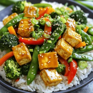 - 1 block (14 oz) firm tofu, drained and cubed - 2 tablespoons soy sauce - 1 tablespoon sesame oil - 2 tablespoons vegetable oil - 1 red bell pepper, sliced - 1 cup broccoli florets - 1 cup snow peas - 1 carrot, julienned - 2 cloves garlic, minced - 1 teaspoon ginger, minced - 2 green onions, chopped - Sesame seeds for garnish - Alternative vegetables (e.g., bell pepper, zucchini, or spinach) - Suggested spices to elevate flavor (e.g., chili flakes or five-spice powder) This meal is simple and tasty. You can switch up the veggies based on what you like. Feel free to add bell peppers, zucchini, or even spinach. Want a kick? Try adding chili flakes or five-spice powder for more flavor. These ingredients make cooking fun and easy. I love using fresh veggies. They add color and nutrition. Tofu gives protein and helps fill you up. You can find the full recipe for more details on how to make this dish shine. 1. First, press the tofu. This step helps it get the right texture. Wrap the tofu in a kitchen towel. Place a heavy object on top for 15 minutes. This will remove extra water. 2. After pressing, cut the tofu into bite-sized cubes. This size helps it cook evenly. 3. Next, mix the soy sauce and sesame oil in a small bowl. This mixture will add great flavor to our stir-fry. 1. Heat vegetable oil in a large skillet or wok over medium-high heat. 2. Add the cubed tofu to the hot pan. Stir-fry it until it gets a golden brown color. This should take about 5 to 7 minutes. Once done, remove the tofu and set it aside. 3. In the same skillet, add minced garlic and ginger. Sauté them for about 30 seconds until they smell good. This adds a nice aroma to the dish. 1. Now, add the sliced bell pepper, broccoli florets, snow peas, and julienned carrot to the skillet. Stir-fry them for about 3 to 4 minutes. You want them to be tender-crisp, not mushy. 2. Return the golden tofu to the skillet. Pour the soy sauce mixture over everything. Toss all the ingredients together. This ensures that the tofu and veggies are well-coated. 3. Stir-fry everything together for another 2 minutes to heat it through. For the full recipe, check the detailed instructions above. Enjoy your healthy dinner! Tofu can be tricky, but with a few tips, you can master it. First, always press your tofu. This helps it soak up flavors. Wrap the tofu in a clean towel. Place a heavy object on top for about 15 minutes. This step is key for better taste. For crispy tofu, use a hot pan. Heat vegetable oil until it shimmers. Add your cubed tofu. Let it cook without stirring for a few minutes. This way, it gets a nice golden color. Flip it to crisp all sides. Different veggies need different cooking times. Broccoli and bell peppers cook quickly. They stay firm and colorful. Cook them for about 3-4 minutes. Snow peas also cook fast, so add them last. Carrots take a bit longer, so add them first. When cooking, add veggies in order of cooking time. Start with carrots, then add the others. This way, everything cooks evenly. Stir them often but gently to keep their shape. Serve your stir-fry with jasmine rice or quinoa. This makes a balanced meal. For a pretty plate, sprinkle sesame seeds on top. Add chopped green onions for a fresh look. These small touches make your meal more inviting. For a fun twist, you can also serve it in a bowl. This adds height and color. Remember, a beautiful plate makes the meal taste even better. For the full recipe, check the details above. {{image_2}} When making your stir-fry, the type of tofu matters. You can choose from three main types: - Firm tofu: This is great for stir-frying. It holds its shape well. - Extra-firm tofu: This has less water and is even denser. It gives a great texture. - Silken tofu: This is softer and blends well in sauces but may not hold up in stir-fry. You can also try flavored or marinated tofu. This adds extra taste without much work. Look for options in stores or marinate your tofu at home. Want to change up the flavors? A Thai-inspired stir-fry can be fun! Use different sauces like: - Peanut sauce: It gives a creamy texture and nutty flavor. - Coconut curry sauce: This adds warmth and sweetness. For a spicy kick, try adding sriracha or chili paste. A little goes a long way. Adjust it to your taste. If you need gluten-free options, swap out soy sauce for coconut aminos. This gives a similar taste without the gluten. For more vegan-friendly options, consider adding tempeh. It’s packed with protein and works well with the stir-fry. You can mix it with the tofu or use it alone. These variations make the dish fun and allow you to explore new flavors. To keep your leftover stir-fry fresh, let it cool first. Then, store it in an airtight container. I recommend using glass containers. They don’t stain, and they help keep the food fresh. You can store the stir-fry in the fridge for up to three days. If you want to freeze your stir-fry, cool it completely before packing. Use freezer-safe bags or containers. Squeeze out as much air as you can to prevent freezer burn. Your stir-fry can stay fresh in the freezer for up to three months. When you're ready to eat, thaw it overnight in the fridge. Reheat it in a pan or microwave. This helps keep the flavor and texture nice. Tofu should be pressed for at least 15 minutes. This helps remove excess water. For extra-firm tofu, you can press it for up to 30 minutes. Silken tofu does not need pressing. Pressing helps the tofu absorb flavors better. Yes, you can use frozen vegetables. They are convenient and often pre-washed. However, frozen veggies can lose some crunch. They may also release more water when cooked. If you want tender-crisp veggies, fresh is best. You can serve the stir-fry with brown rice or quinoa. These add fiber and nutrients. For extra protein, try adding shrimp or chicken. A side salad can also complement the dish well. To reheat stir-fry, use a skillet over medium heat. Add a splash of water or oil to keep it moist. Stir-fry for about 5 minutes until heated through. You can also use a microwave, but it may make it soggy. Yes, this stir-fry can be gluten-free. Just use gluten-free soy sauce or coconut aminos. Make sure all other ingredients are also gluten-free. This way, you can enjoy a safe meal. You can find the full recipe for "Quick Veggie Stir-Fry with Tofu" [here](#). It has all the details you need to make this delicious dish! This blog post provides an easy guide to making a tasty veggie stir-fry with tofu. You learned about the key ingredients, step-by-step cooking steps, and tips for perfect texture. Personalization options let you create your unique dish. Remember, use fresh veggies and adjust flavors to your liking. Store any leftovers properly to maintain freshness. Enjoy this healthy, delicious meal that fits your preferences. Happy cooking!