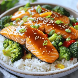 - 2 salmon fillets - 1 cup jasmine rice - 1/4 cup soy sauce (low sodium) - 2 tablespoons honey - 1 tablespoon rice vinegar - 1 tablespoon sesame oil - 2 garlic cloves, minced - 1 teaspoon fresh ginger, grated The salmon fillets are the star here. They provide rich flavor and healthy fats. Jasmine rice offers a light and fragrant base. The teriyaki sauce combines soy sauce, honey, rice vinegar, sesame oil, garlic, and ginger. These ingredients create a sweet and savory blend that perfectly complements the fish. - 1 cup broccoli florets - 1/2 red bell pepper, sliced Broccoli florets add crunch and color. They are full of vitamins. Sliced red bell pepper brings a sweet and vibrant touch to the dish. Both vegetables cook quickly and enhance the meal's overall nutrition and taste. - 1 green onion, chopped (for garnish) - Sesame seeds (for garnish) - Salt and pepper to taste Chopped green onion adds freshness and a pop of color. Sesame seeds provide a nutty flavor and a nice crunch. Salt and pepper enhance the dish, balancing the sweetness of the teriyaki sauce. These garnishes make the dish visually appealing and tasty. For the full recipe, check out the details above. To make fluffy jasmine rice, start by rinsing the rice. Place it in a fine-mesh strainer and run it under cold water. Keep rinsing until the water runs clear. This removes excess starch and helps prevent sticking. Next, in a medium saucepan, add 1 cup of rinsed rice and 2 cups of water. Bring it to a boil over medium heat. Then, reduce the heat to low. Cover the pot and let it simmer for about 15 minutes. The rice will absorb the water and cook perfectly. After 15 minutes, remove the pot from heat but keep it covered. Let it sit for another 5 minutes. This resting time makes the rice even fluffier. Now, let's make the teriyaki sauce. In a small saucepan, combine 1/4 cup of low-sodium soy sauce, 2 tablespoons of honey, 1 tablespoon of rice vinegar, and 1 tablespoon of sesame oil. Add 2 minced garlic cloves and 1 teaspoon of grated ginger. Whisk the ingredients together. Heat the mixture over medium heat. Bring it to a gentle simmer, stirring often. Let it cook for about 5 minutes until it thickens slightly. Remove it from heat and set it aside. This sauce is sweet and savory, enhancing the salmon's flavor. For the salmon, season both fillets with salt and pepper. Heat a skillet over medium-high heat. Once hot, place the salmon skin-side down in the pan. Cook it for about 4 to 5 minutes without moving it. Carefully flip the fillets. Brush some teriyaki sauce on top. Cook for an additional 3 to 4 minutes. The salmon should be cooked through but still tender. The skin will be crispy, adding great texture to the dish. Now, let’s prepare the vegetables. In the same skillet, add 1 cup of broccoli florets and 1/2 sliced red bell pepper. Sauté them for about 3 to 4 minutes. You want them to stay tender-crisp, so avoid overcooking. If they seem dry, add a splash of water. This helps steam them slightly. The bright colors and crunch will make your rice bowls pop. To serve, take a bowl and add a scoop of fluffy jasmine rice. Place the teriyaki salmon on top of the rice, along with the sautéed vegetables. Drizzle the remaining teriyaki sauce over everything. For a finishing touch, sprinkle chopped green onion and sesame seeds on top. This adds flavor and a nice look to your bowls. Enjoy your delicious teriyaki salmon rice bowls! For the complete recipe, check out the Full Recipe. To make your teriyaki salmon rice bowls even better, try adding spices like chili flakes or black pepper. You can also mix in a splash of orange juice for a citrus twist. Pair your dish with pickled ginger or a side of miso soup. This adds depth and makes the meal feel complete. If you want to switch things up, you can use chicken or tofu instead of salmon. Both options work well with teriyaki sauce. For rice, jasmine is great, but brown rice or quinoa can also be delicious. You can swap vegetables too! Try snap peas, carrots, or bok choy for a new flavor. To get that perfect pan-sear, heat your skillet well before adding salmon. Cook skin-side down for a crisp finish. If you prefer grilling, marinate the salmon first for extra flavor. Baking is another option; just place the salmon on a parchment-lined tray and bake at 400°F for about 12-15 minutes. Each method brings out unique flavors in the salmon. For the full recipe, check the previous section. {{image_2}} You can switch up the protein in this dish easily. If you want chicken, use boneless, skinless thighs. They will soak up the teriyaki sauce well. For a plant-based choice, go for tofu. Choose firm tofu, press it, and cut it into cubes. Cook it the same way as salmon. It will absorb the sauce and taste great. You can use different types of rice for these bowls. Brown rice adds a nutty flavor and is a bit chewy. Cauliflower rice is a low-carb option and cooks quickly. If you want a protein boost, try quinoa. It cooks fast and has a pleasant texture. All these options work well with the teriyaki flavor. Adding seasonal veggies makes your bowl fresh and colorful. In spring, use asparagus or snap peas. In summer, try zucchini or corn. Fall brings great choices like butternut squash. Winter is perfect for root veggies like carrots or sweet potatoes. Don't forget leafy greens like spinach or kale. They add nutrition and a nice crunch! To keep your teriyaki salmon rice bowls fresh, store leftovers in the fridge. Place the salmon and rice in separate containers. This helps maintain their textures. Use airtight containers to avoid air exposure. Consume leftovers within three days for the best taste. When reheating salmon, do it gently to keep it moist. You can use the microwave on low power. Cover the salmon with a damp paper towel to trap steam. For rice, add a splash of water before microwaving. This helps prevent it from drying out. Heat the rice for about one minute. Stir and check if it's warm enough. If you want to freeze portions, let the salmon and rice cool first. Place them in freezer-safe bags. Squeeze out as much air as you can. Label the bags with the date. For the best taste, eat frozen portions within three months. When you’re ready to eat, thaw overnight in the fridge. This keeps the food safe and tasty. Making Teriyaki Salmon Rice Bowls takes about 30 minutes. - Prep time is around 10 minutes. - Cooking time is about 20 minutes. Yes, you can use store-bought teriyaki sauce. However, homemade sauce gives better flavor. Homemade sauce uses fresh ingredients. This makes it taste bright and vibrant. Store-bought options may contain preservatives. Always check labels for quality. Salmon is packed with nutrients. It is rich in omega-3 fatty acids, which help your heart. - Salmon supports brain health and reduces inflammation. - It is a great source of protein and vitamins. Eating salmon can boost your mood and energy levels. Yes, you can make this recipe ahead. Cook the salmon and rice, then store them. - Keep them in airtight containers in the fridge. - You can prepare the teriyaki sauce in advance too. When ready to eat, just reheat everything together. Many sides pair well with Teriyaki Salmon Rice Bowls. Here are some great options: - Steamed edamame - Cucumber salad - Miso soup - Pickled vegetables These sides add flavor and texture to your meal. Try mixing and matching! In this post, we explored how to make tasty Teriyaki Salmon Rice Bowls. We covered key ingredients like salmon, jasmine rice, and fresh veggies. You learned how to cook rice, make flavorful teriyaki sauce, and perfectly sauté vegetables. I shared tips on storage and variations, ensuring you can customize your dish. These bowls are not only easy but also packed with nutrition. Now, enjoy creating memorable meals that your whole family will love. Happy cooking!