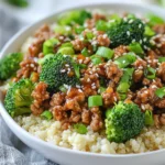 For this dish, I use 1 pound of ground turkey. Ground turkey is lean and cooks quickly. It absorbs flavors well, making it perfect for this meal. You can also use chicken if you prefer. You will need 3 cups of fresh broccoli florets. Fresh broccoli adds color and crunch. It is packed with vitamins and cooks in just a few minutes. You can chop it into bite-sized pieces for easy eating. Here are the key flavor boosters for the recipe: - 2 tablespoons olive oil - 3 cloves garlic, minced - 1 inch fresh ginger, grated - 2 tablespoons soy sauce (or tamari for gluten-free) - 1 tablespoon sesame oil - 1 tablespoon honey or maple syrup - 1 teaspoon red pepper flakes (optional) The olive oil gives a nice base. Garlic and ginger add depth and warmth. Soy sauce brings a salty umami kick. Sesame oil adds a nutty flavor, while honey or maple syrup balances everything out. Red pepper flakes can spice it up if you like heat. {{ingredient_image_1}} Start by heating a large skillet on medium-high heat. Add 2 tablespoons of olive oil. Wait until the oil warms up. This step is important for a nice sear on the turkey. Next, add 1 pound of ground turkey to the skillet. Use a spatula to break it up as it cooks. Stir and cook for about 5 to 7 minutes. The turkey should turn brown and no longer be pink. This step ensures the meat is fully cooked and safe to eat. Once the turkey is cooked, stir in 3 cloves of minced garlic and 1 inch of grated fresh ginger. Cook this mixture for another 1 to 2 minutes. The smell will fill your kitchen and make you hungry. This step adds a burst of flavor to your dish. When picking ground turkey, look for lean options. Aim for 93% lean or higher. This gives rich flavor without too much fat. If you can, buy organic turkey. It often tastes better and is healthier. Always check the color. Fresh turkey should be light pink. Avoid any that looks gray or has a smell. To cook broccoli, start with fresh florets. Wash them well and cut into small pieces. Steam or sauté for bright color and crunch. If you sauté, add them to the skillet with turkey after 3 minutes. Cook until they are bright green and tender. This keeps their nutrients and taste. Avoid overcooking. You want them crisp, not mushy. You can add more fun to your bowls! Try different sauces like teriyaki or peanut sauce. For a kick, use more red pepper flakes. Add nuts for crunch, too. Try cashews or almonds. You can also mix in other veggies, like bell peppers or carrots. This gives more color and taste. Don’t be scared to experiment! Pro Tips Use Fresh Ingredients: Fresh broccoli and ginger will enhance the flavor of the dish significantly compared to frozen or dried alternatives. Adjust Spice Level: Customize the heat by varying the amount of red pepper flakes to suit your taste preference. Meal Prep Friendly: This dish can be made in advance and refrigerated for a quick, healthy meal throughout the week. Garnish for Flavor: Don’t skip the sesame seeds and green onions—they add both flavor and visual appeal to the dish. {{image_2}} To make this dish gluten-free, simply swap regular soy sauce with tamari. Tamari has a similar taste but is safe for those with gluten sensitivities. You can also check labels for other sauces. Always ensure that any added condiments are gluten-free to keep the meal safe. If you prefer a vegetarian dish, replace ground turkey with cooked lentils or chickpeas. These options provide protein and keep the dish hearty. Use the same seasonings and cooking steps. You might also want to add more veggies like bell peppers or mushrooms for extra flavor. To control the heat, adjust the red pepper flakes. For a mild version, skip them entirely. If you love spice, add more flakes or a dash of hot sauce. You can also include fresh chili peppers while cooking for an extra kick. Adjust the flavors to fit your taste! To keep your Ground Turkey Broccoli Bowls fresh, store them in an airtight container. This helps prevent moisture and keeps flavors intact. Place the bowls in the fridge within two hours after cooking. They can stay good for up to four days. Always let them cool slightly before sealing. If you want to freeze your bowls, let them cool completely first. Use freezer-safe containers or bags. Make sure to remove excess air to avoid freezer burn. These bowls can last up to three months in the freezer. When you’re ready to eat, thaw them in the fridge overnight before reheating. To reheat, you can use the microwave or a skillet. For the microwave, heat in 30-second intervals until hot. Stir in between to ensure even heating. If you use a skillet, add a splash of water and cover. Heat over medium until warmed through. Enjoy your meal without losing any taste! Yes, you can use frozen broccoli. Just be sure to thaw it first. Frozen broccoli cooks faster than fresh. Add it to the skillet and stir for about 3 minutes. This helps to keep the broccoli bright and tender. You can prepare the ground turkey mix and cook the broccoli ahead. Store the cooked mix in the fridge. Reheat it when you are ready to eat. You can also cook the rice or quinoa ahead. Keep everything in separate containers. This makes for a quick meal later. Ground turkey broccoli bowls are great on their own. You can serve them over brown rice or quinoa. Add a side of steamed veggies for more color. For extra crunch, sprinkle sesame seeds or green onions on top. If you like spice, serve with chili sauce on the side. This blog post covered ground turkey and fresh broccoli. I shared how to cook them perfectly with simple seasonings. You learned key tips for choosing and preparing ingredients. I also included variations like gluten-free and vegetarian options. Lastly, I offered storage tips to keep your meals fresh. Remember, cooking should be fun. Experiment with flavors and make it your own. Enjoy making healthy dishes that taste great!